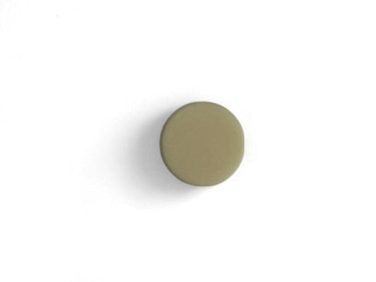 A round conditioner bar with a solid green color, with no visible packaging.